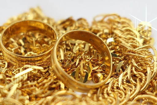 A large amount of gold jewelry is pictured all together in a large pile.