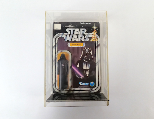 A Darth Vader action figure from the movie Star Wars is pictured. It is in mint condition.